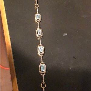 Gold bracelet with blue stones.